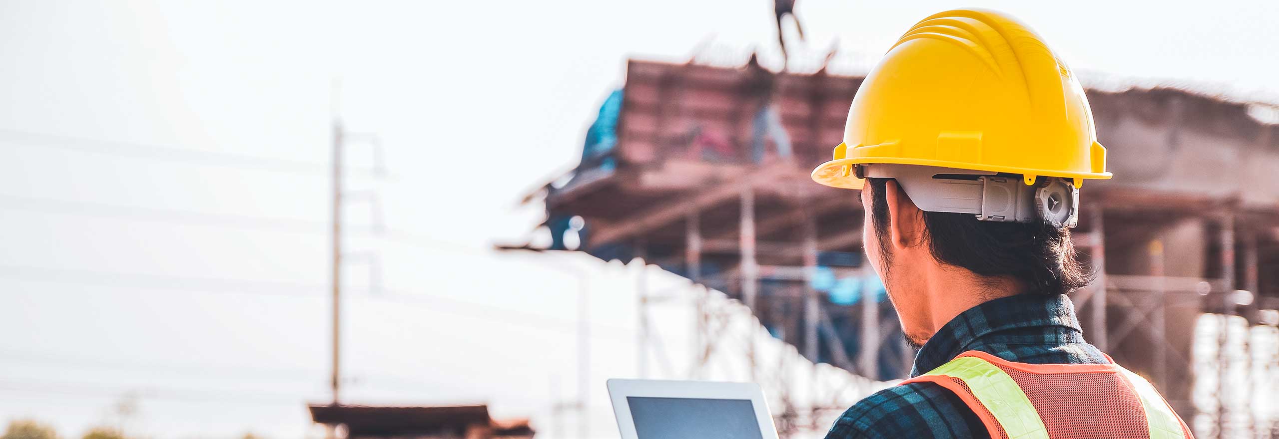 A construction worker looks at a digital display for information