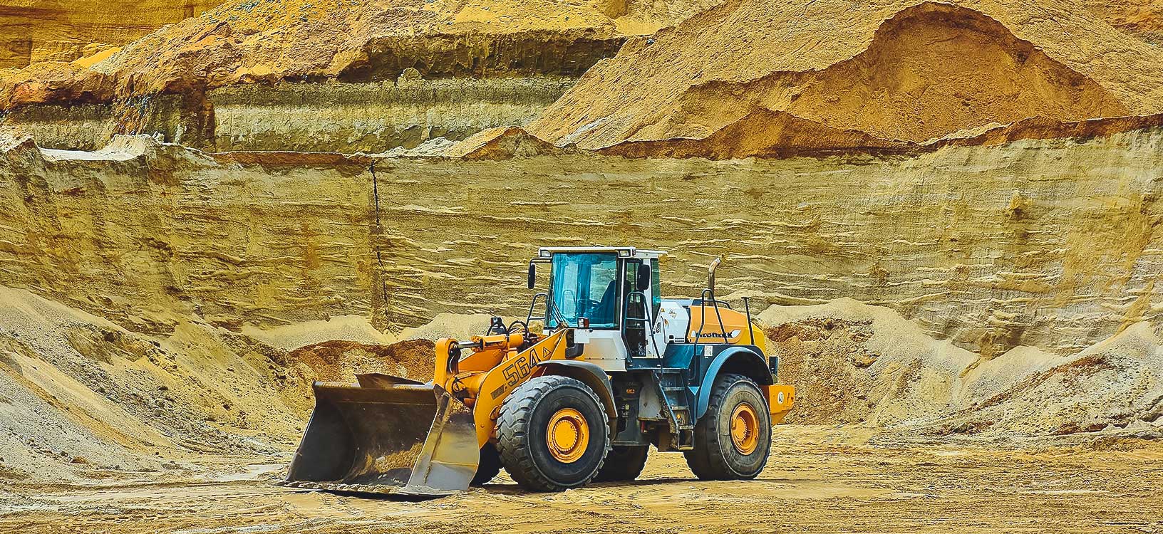 front-end loader parked in middle of mine site