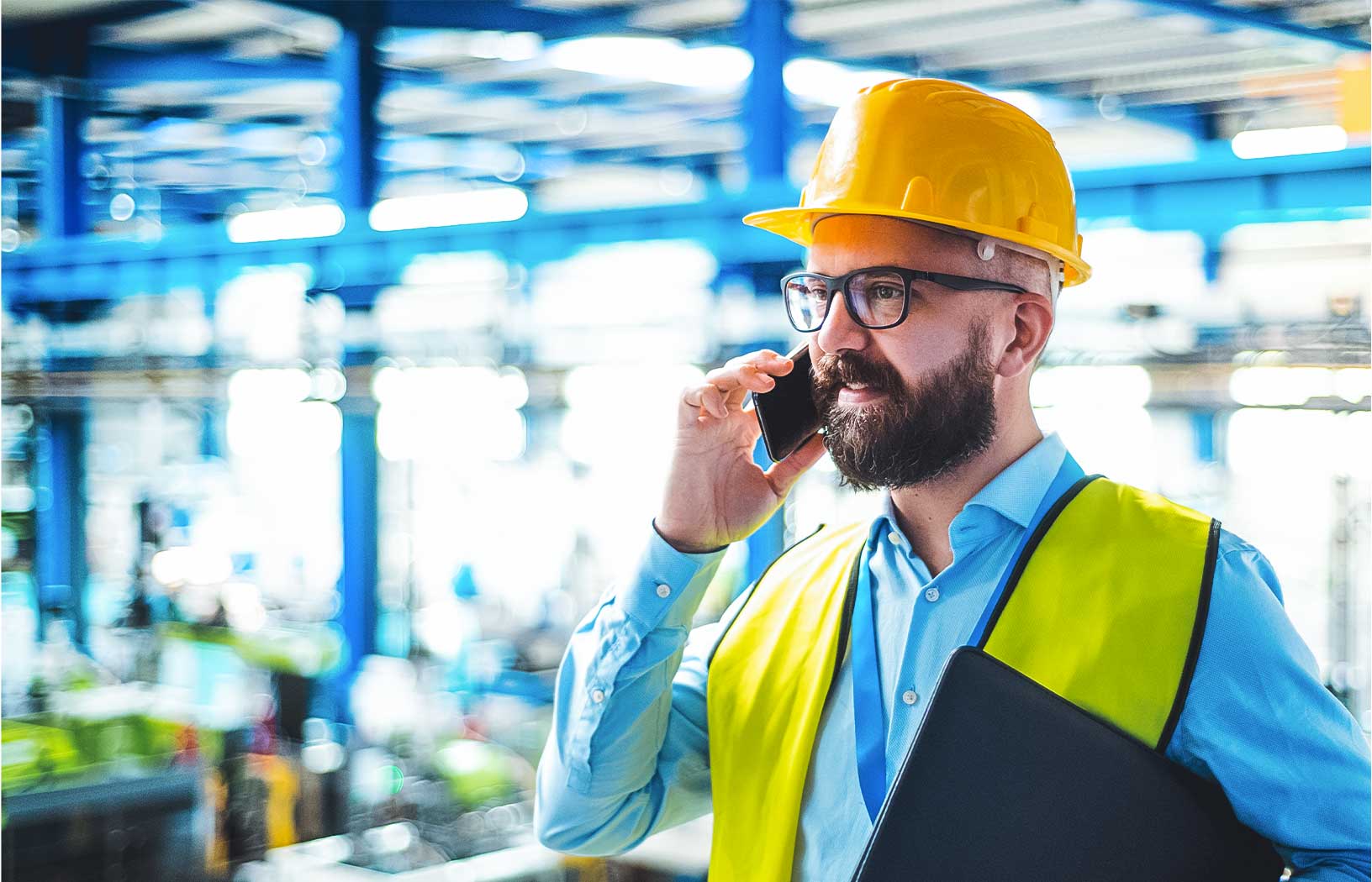 Worker in hard hat conducting equipment analysis