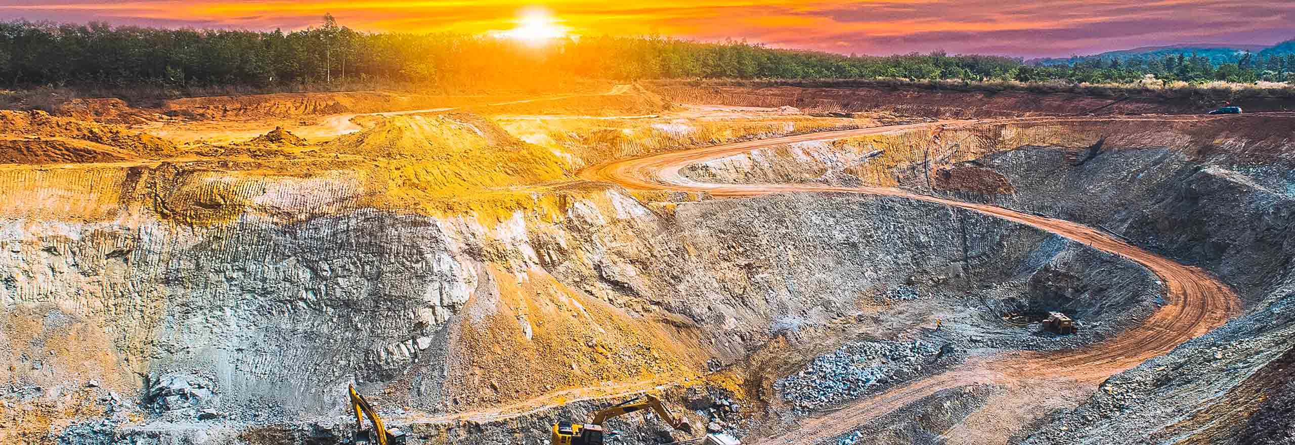 open pit mine at sunset