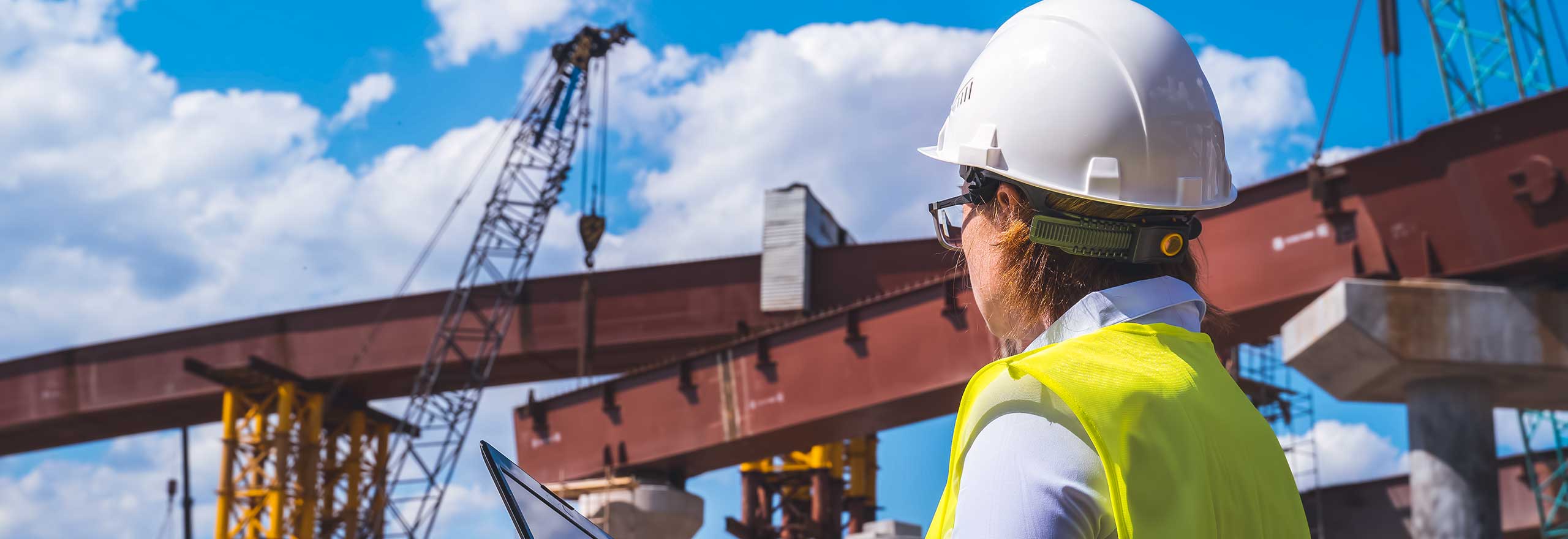 An onsite construction worker with a laptop