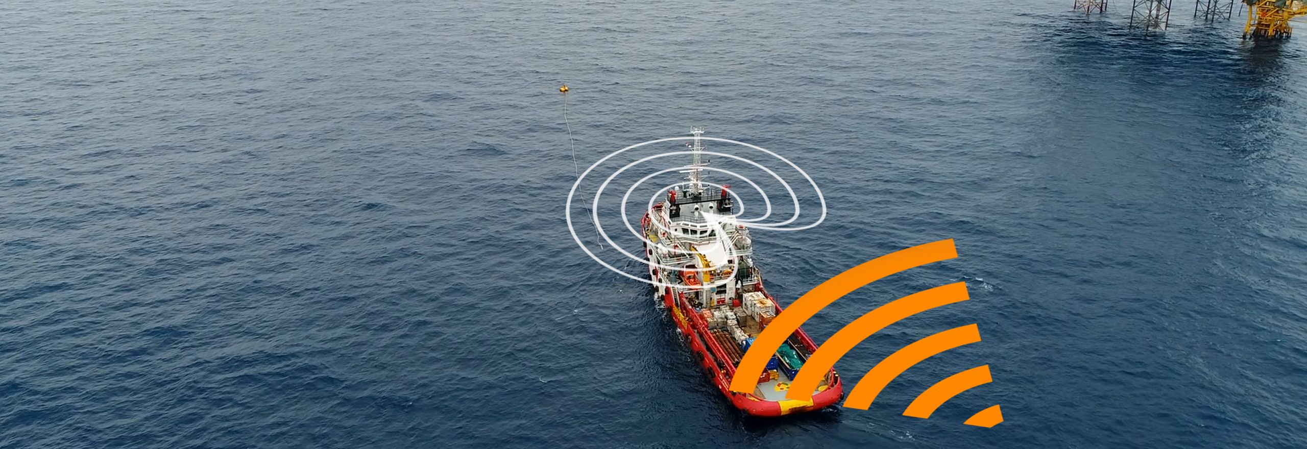 A red vessel on the ocean with an offshore oil rig next to it with white and orange lines above the vessel depicting anti-jamming.