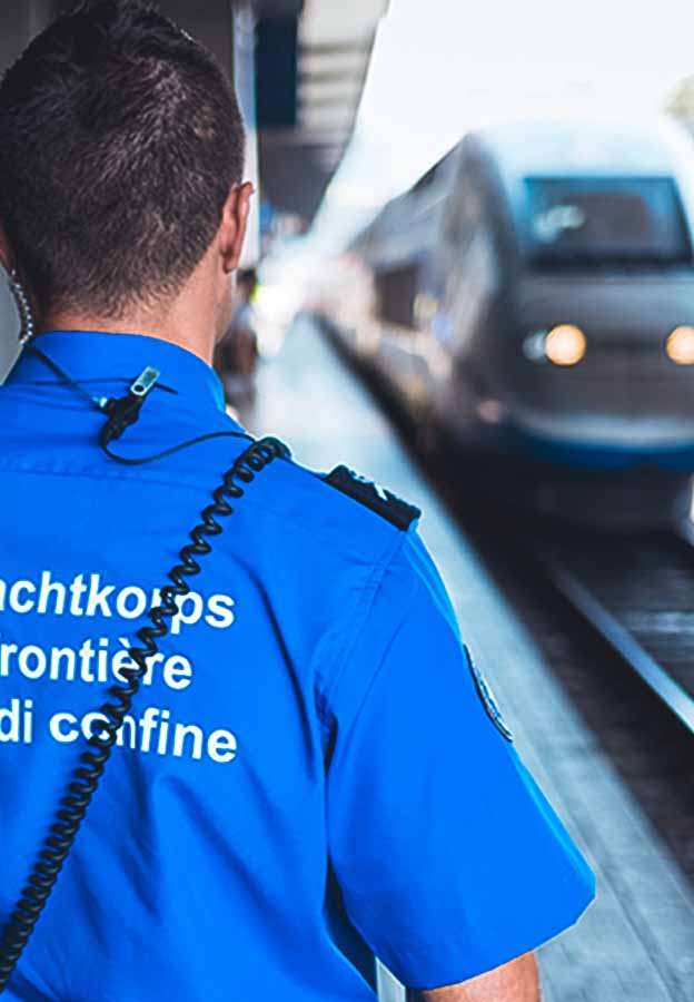 Personnel watches an approaching train 