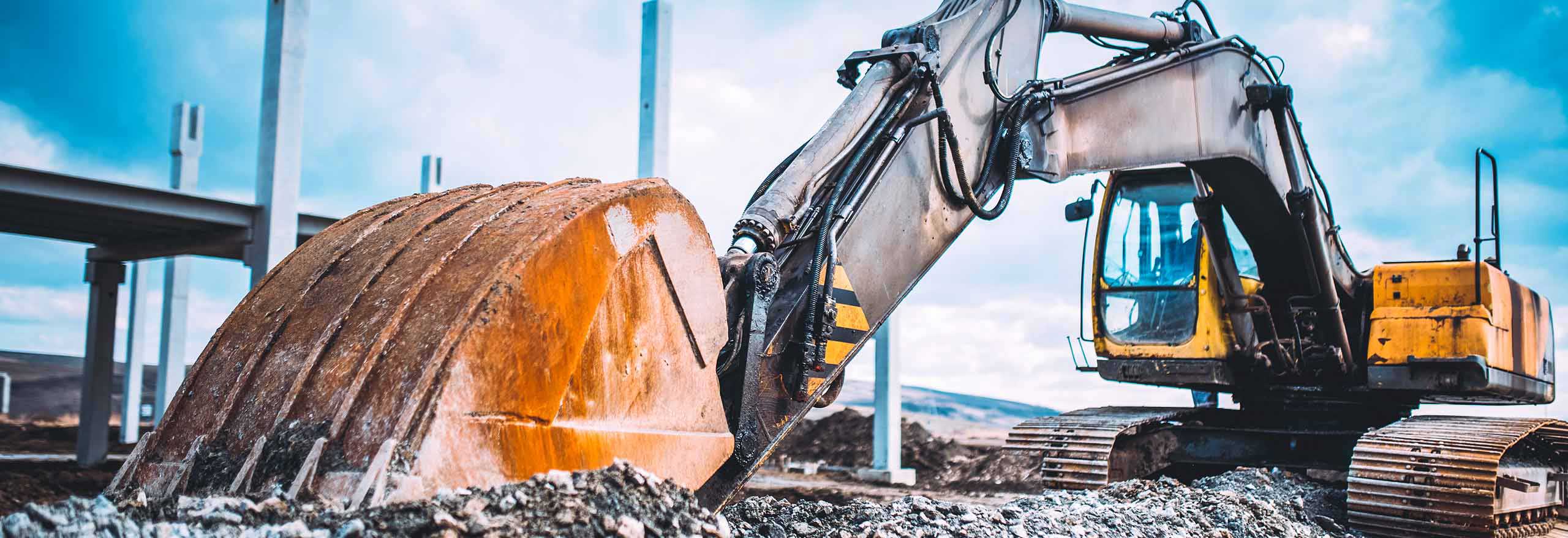 Excavator prepping land for new tarmac construction