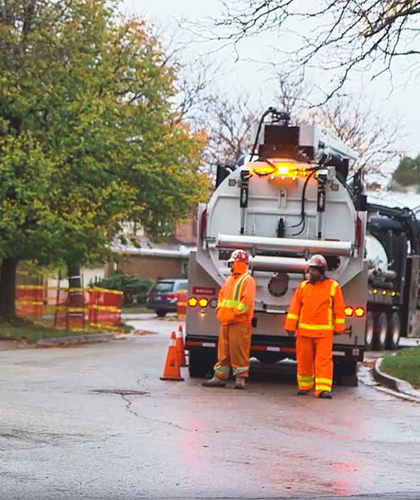 A team makes repairs to a network in a neighborhood 