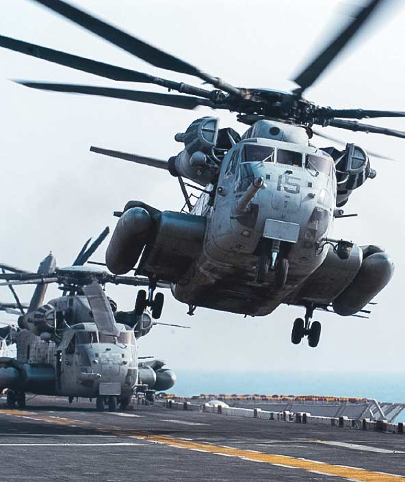 Two military aircraft take off from a runway